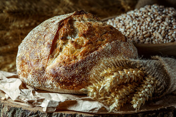 Bread, traditional sourdough bread cut into slices on a rustic wooden background. Concept of...
