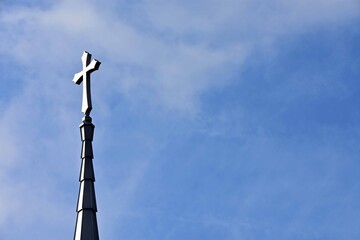 Church steeple on a hazy blue sky background