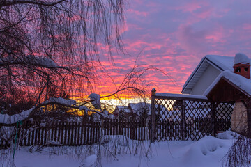 Twilight, country winter scene, colorful dramatic sky during sunset.