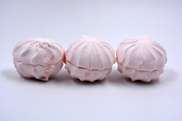 Beautiful and tasty air white pink marshmallow made in Ukraine is located on a white background. 