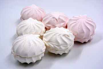 Beautiful and tasty air white pink marshmallow made in Ukraine is located on a white background. 