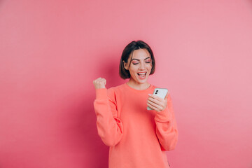 Excited young woman amazed by unbelievable shopping mobile app sale message looking at smartphone,...
