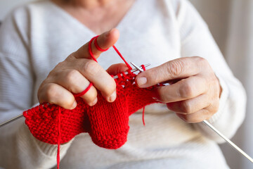Handmade hobby crafts. mature woman hands knit crochet.
