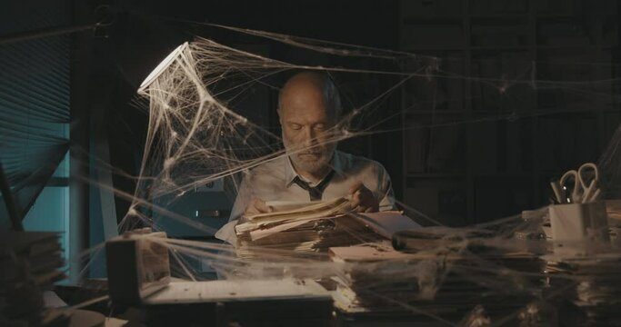 Businessman searching for files in the abandoned office