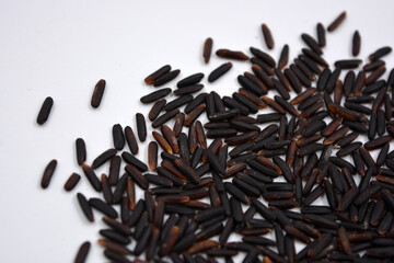 Wild unwanted handsome black rice raised on a white background.