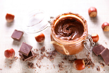 chocolate spread in jar and hazelnut