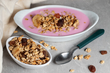 Delicious yogurt with granola served on a white bowls.