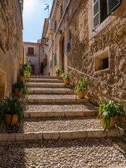 Fototapeta na wymiar street with stairs and plants in the old town of Campanet, majorca, spain