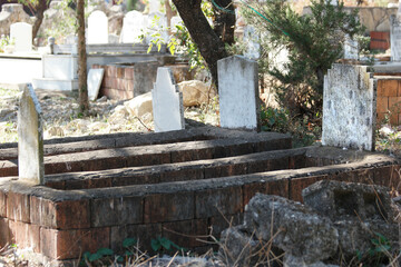 Fototapeta na wymiar View of Muslim cemetery with graves and headstones. Muslim graveyard background. Antalya, Turkey.