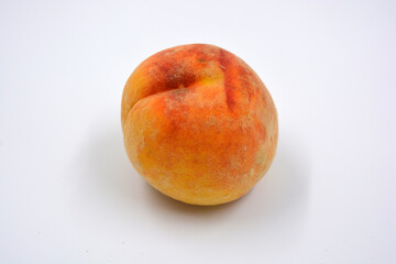 Tasty and useful fresh fruits, ripe red and orange peaches with a terry white skurt are located on a white background. 