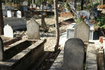 Muslim tombstones in graveyard. Graves with headstones at Muslim cemetery in summer season.