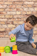 Little boy plays at home on the floor during quarantine