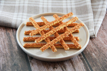 long salted sticks of crackers with sesame sprinkles