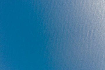 Blue sea water surface. Aerial top view. Small waves and sun reflection on the water. Splendid surface of the Adriatic sea near Croatia, Makarska riviera.