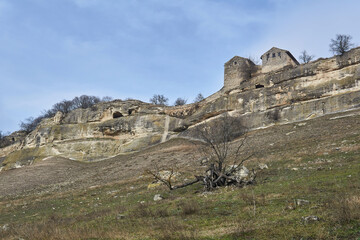 view of the Karaite kenassas on the edge of a cliff in the ancient cave city of Chufut-Kale, Crimea