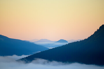 Abstract photo. The peaks of the mountains in the fog in the dawn haze. Vintage hipster abstract...