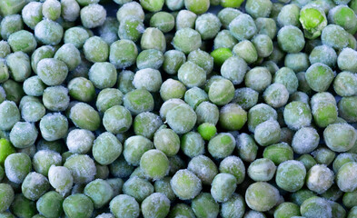 Fresh frozen green peas close-up.