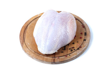 Chicken breast with skin on a wooden board. White background. Isolated.
