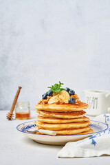 Pancakes with banana, walnut, honey and caramel for a breakfast. Selective focus
