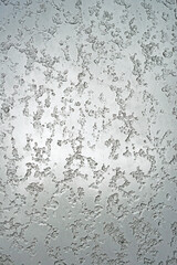 Texture. Background. Wet snow on the window pane. Ice and patterns of winter