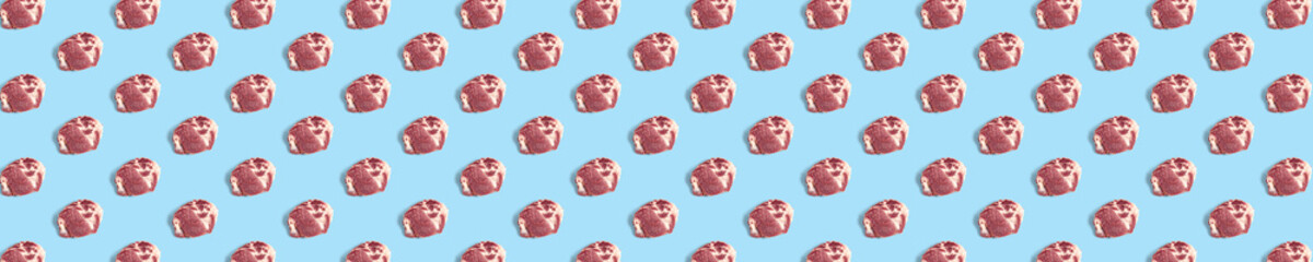 background with raw pork meat slices on blue background, raw food background, not pattern, banner wide shoot