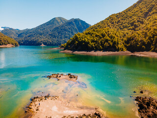 turquoise lake surrounded by mountains and forests