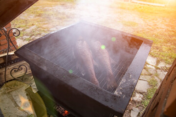 river fish smoked on the grill. artistic focus