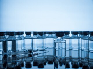 Vaccine bottles and syringe injection. Medicine in ampoules. Glass vials for liquid samples in laboratory.