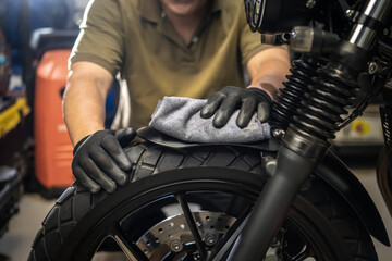 Biker man cleaning motorcycle , Polished and coating Wax Spray on front fender. repair and...