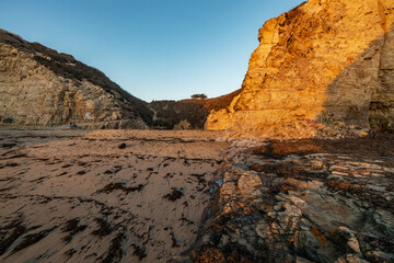 A picturesque sunset in Shark Fin cove, ocean, rocks, beautiful sky. Santa Cruz and Davenport have some of the most beautiful beaches in California.