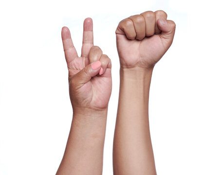 Woman's hands forming the peace sign and the fight sign