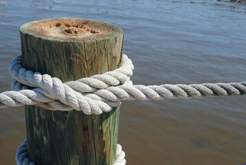 Pier rope hanging above the harbor water