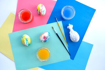 Multicolored Easter eggs on a colored geometric background. Easter concept, Easter DIY, top view