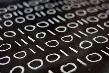 Ceros y unos escritos con tiza  en una pizarra, sistema binario