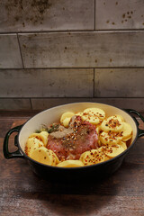 Raw meat with potatoes in a rabbit.