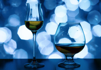 Tulip and snifter glass on a blue bokeh background