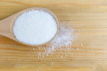 Pure Collagen Powder in wooden spoon.