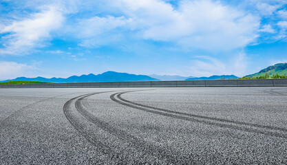 Asphalt highway and green mountain scenery.