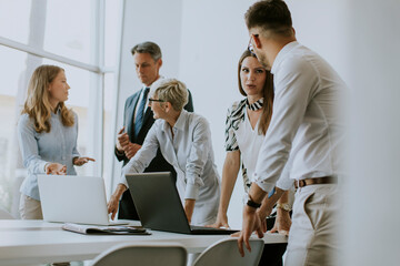 Group of business people working together and preparing new project on a meeting in office