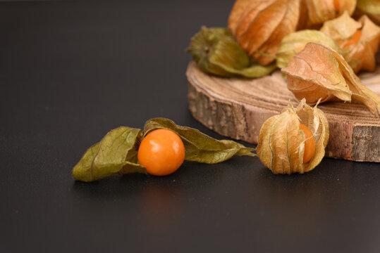 Ripe berry physalis on the wooden board.