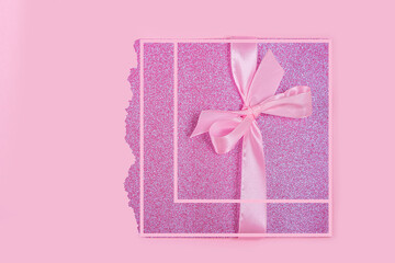 Invitation greeting card or gift box for mothers, Valentines, womens day, birthday. Pink shiny template for lettering or graphic design with ribbon bow. Copy space for text, mock up.