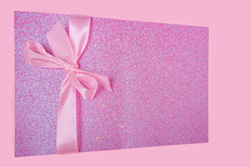 Invitation greeting card or gift box for mothers, Valentines, womens day, birthday. Pink shiny template for lettering or graphic design with ribbon bow. Copy space for text, mock up.