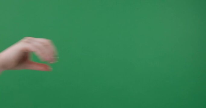 Woman hand sign flicking off over green background