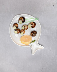 Tasty snails stuffed with herbs, oil. France dish of Burgundy style.