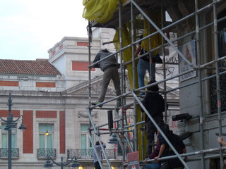 Protesters climbing on scaffolding. 15-M protests