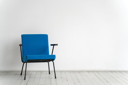 Blue chair on a white wall background in an empty room