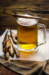 Beer in a glass beer mug and smoked fish