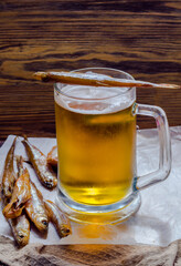 Beer in a glass beer mug and smoked fish