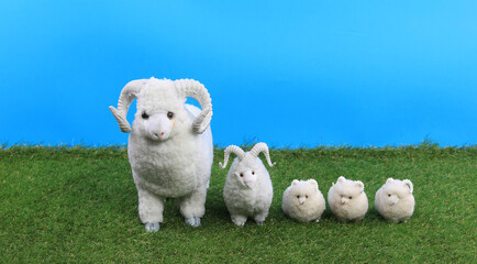 Obraz na płótnie Canvas fluffy toy rams on artificial grass