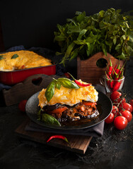 Traditional Greek moussaka on a dark background. Selective focus. - 417875561